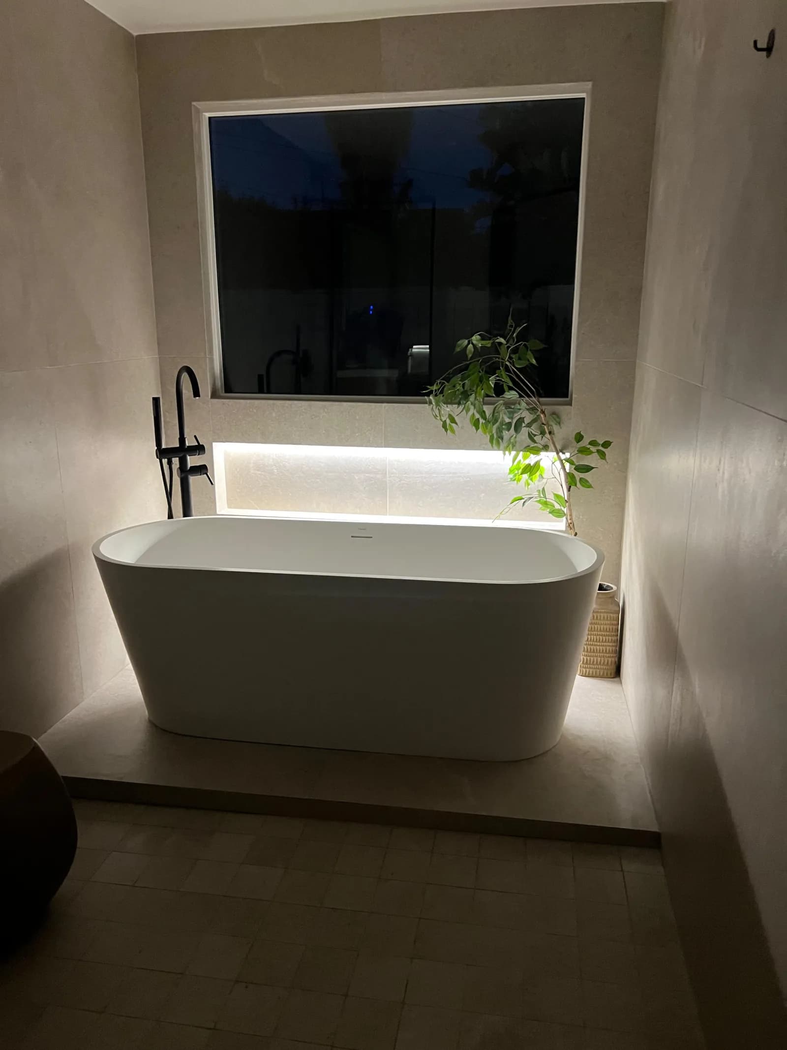 Freestanding soaking tub bathroom with backlit niche