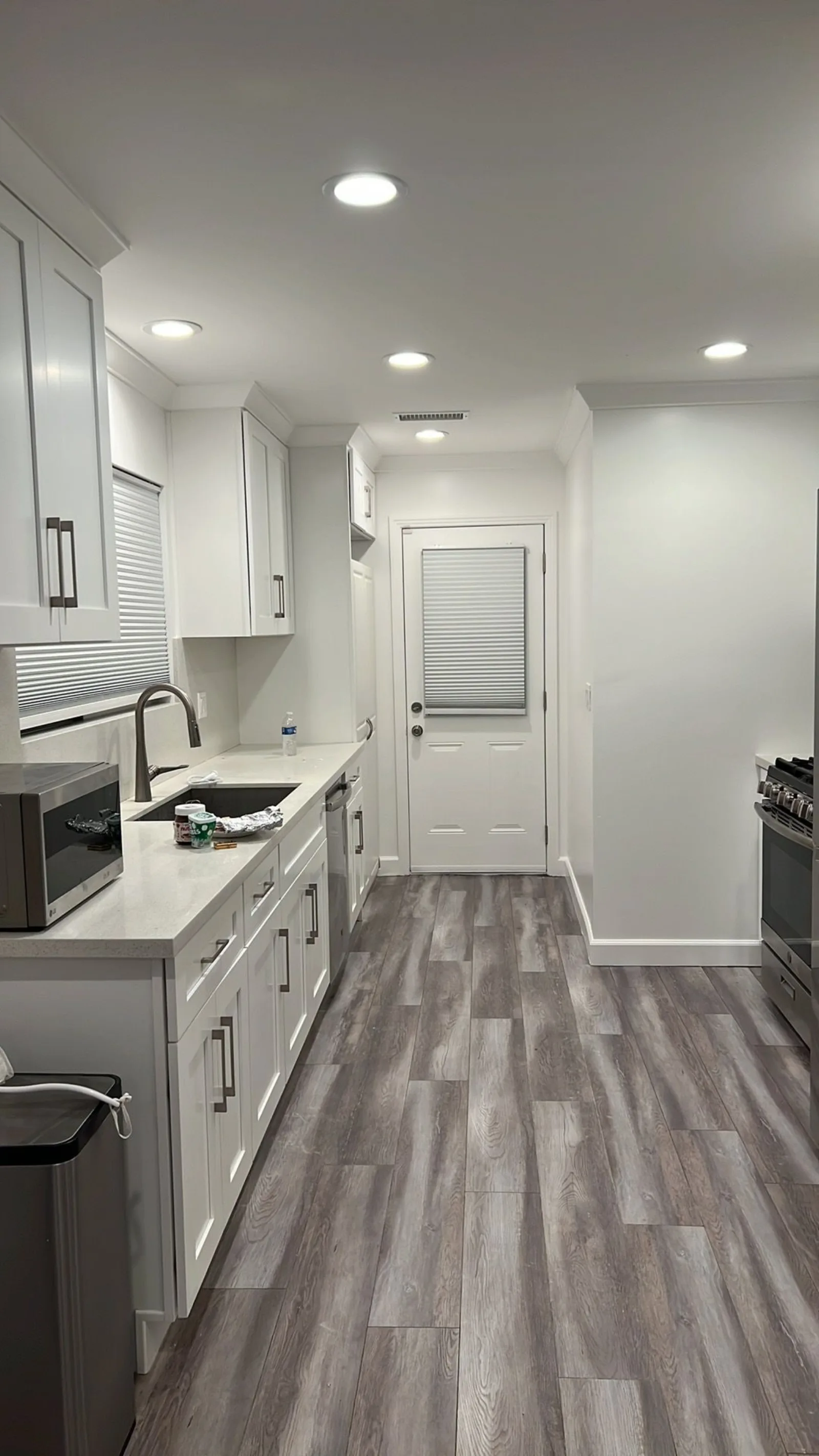 Galley kitchen remodel with white cabinets and quartz counters