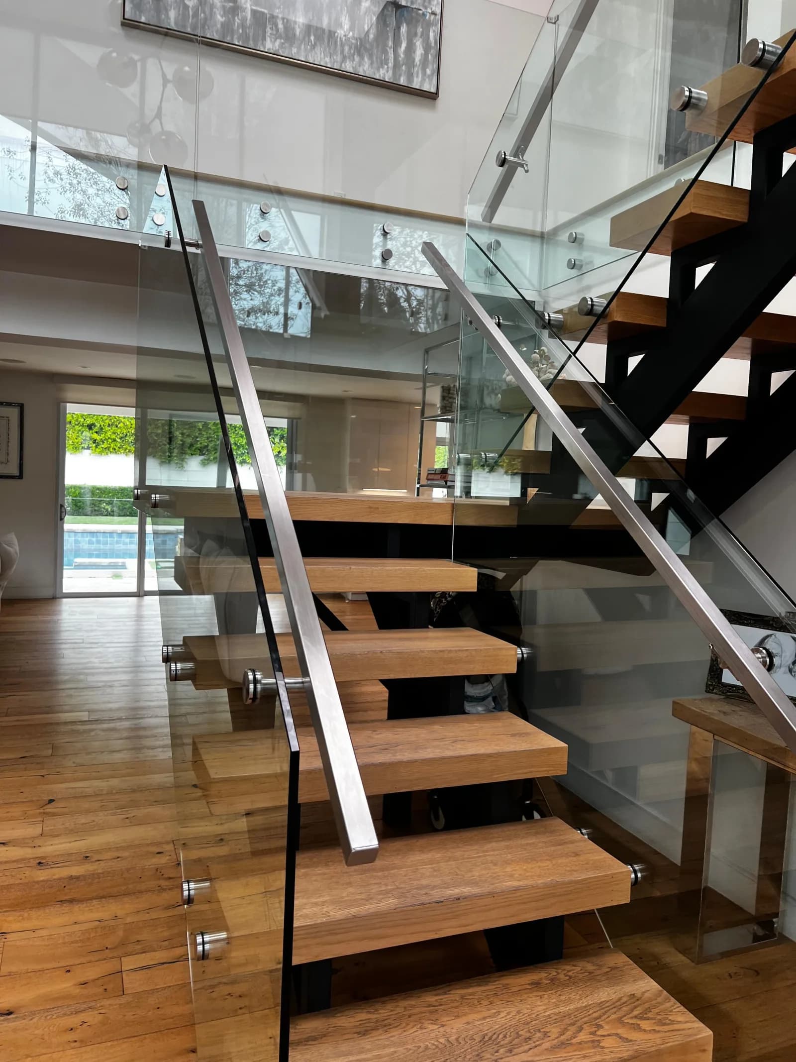 Open wood staircase with stainless and glass railings